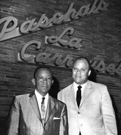 James and Robert Paschal photographed in front of the Paschal's La Carrousel neon sign