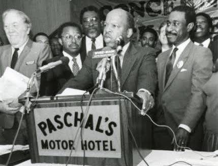 Leaders gathered at the Paschal's Motor Hotel podium for a press conference